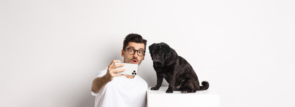 Pet owner using mobile app with dog representing AI app for pets and advanced pet care technology